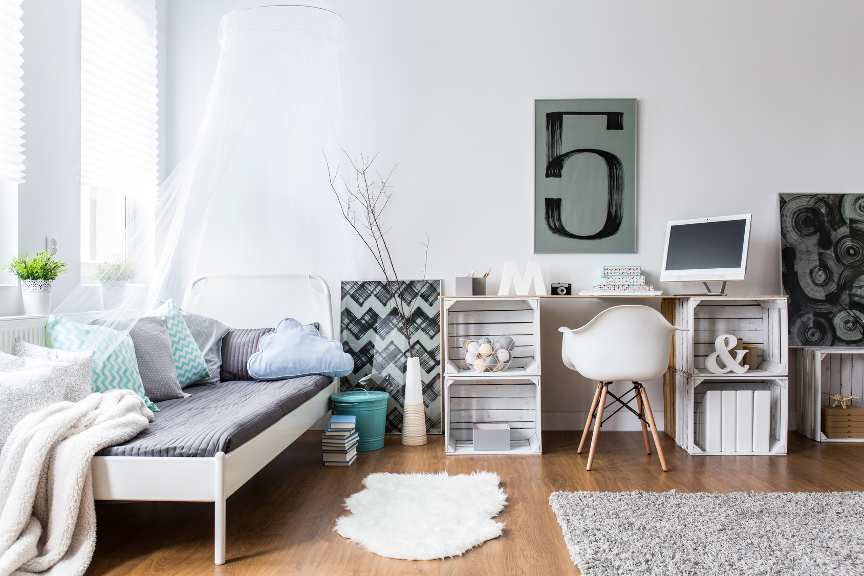 Cozy modern bedroom with hipster design. Single bed and wooden desk in room with wooden floor